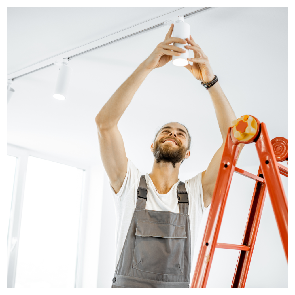 handyman installing light
